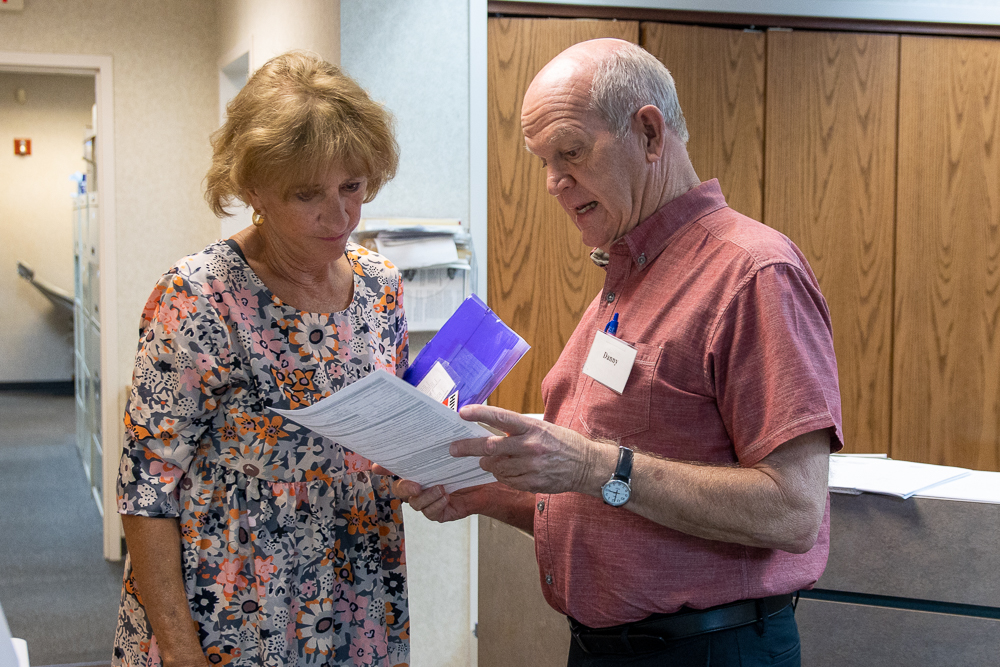 Photo of a Community Care Center volunteer helping a patient.